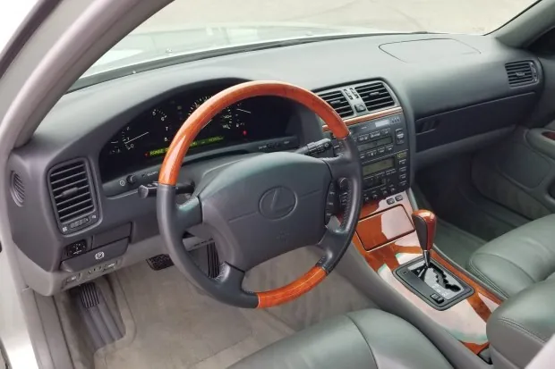 Interior of 1998 Lexus LS400 with wood-trimmed steering wheel.