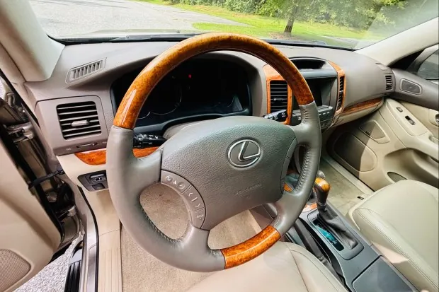Lexus GX470 steering wheel and dashboard interior.