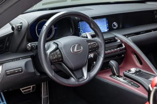 Lexus LC500 interior with steering wheel and dashboard.