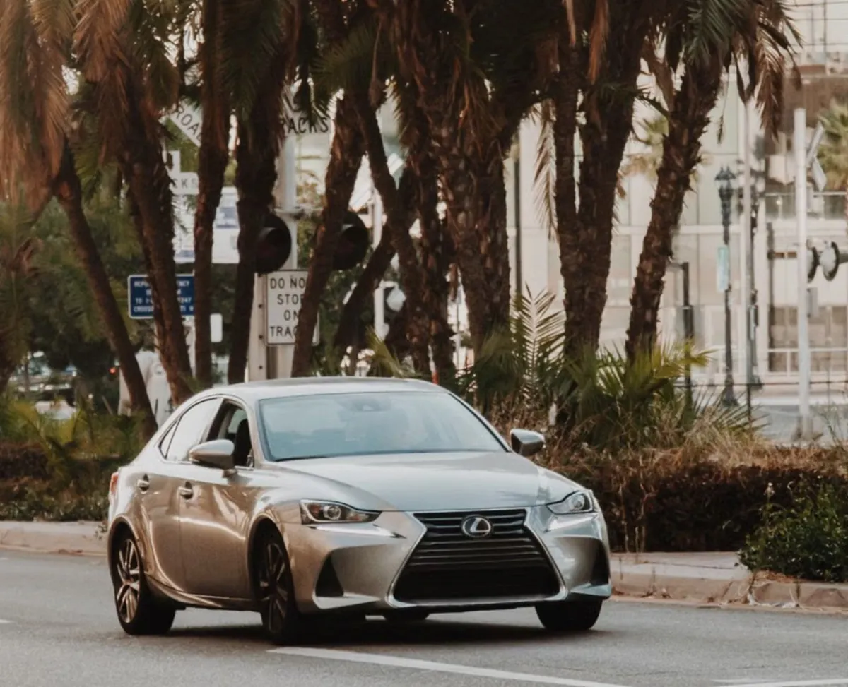 Silver Lexus sedan on city street