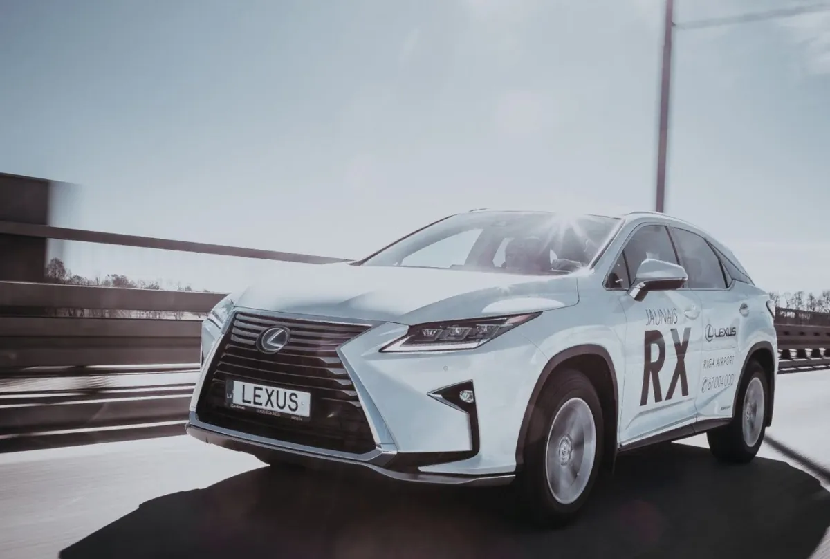 White Lexus RX driving on a highway