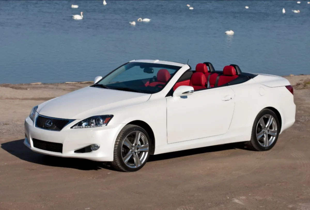 White convertible Lexus by a lake