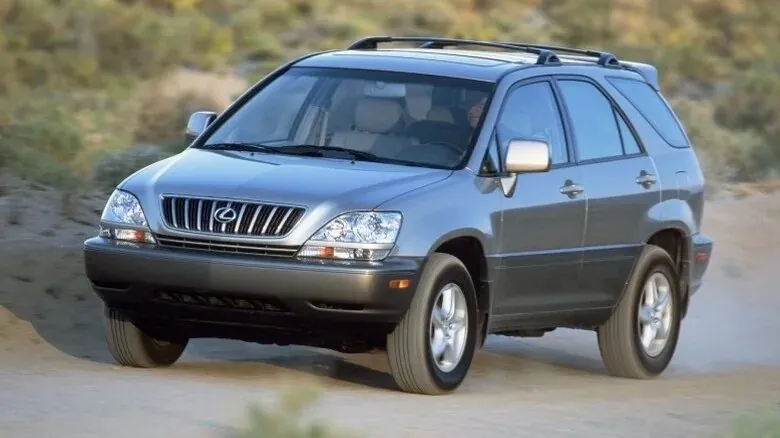 Silver Lexus RX driving on a dirt road.