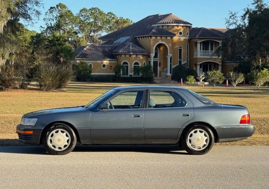 1990 Lexus LS400 parked in front of a mansion