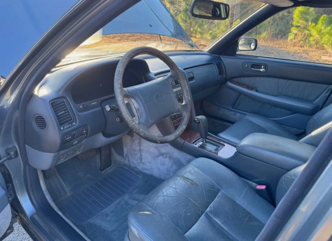Interior of a 1990 Lexus LS400 with worn leather seats.