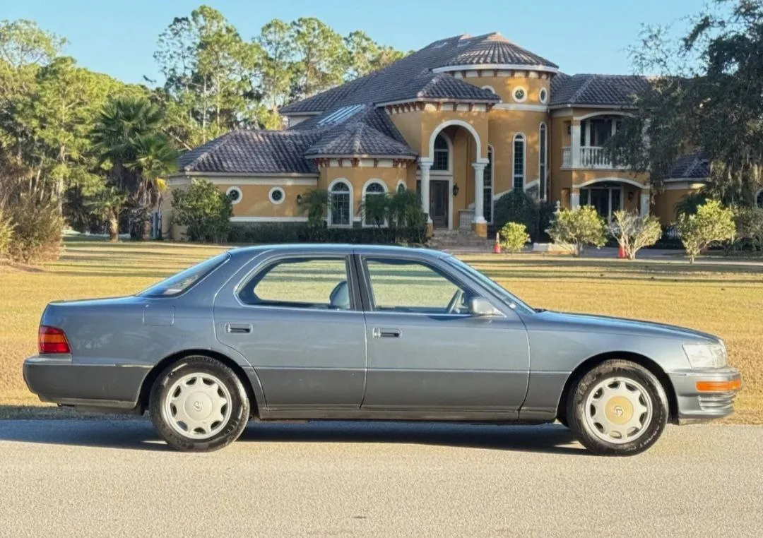 1990 Lexus LS400 parked in front of mansion