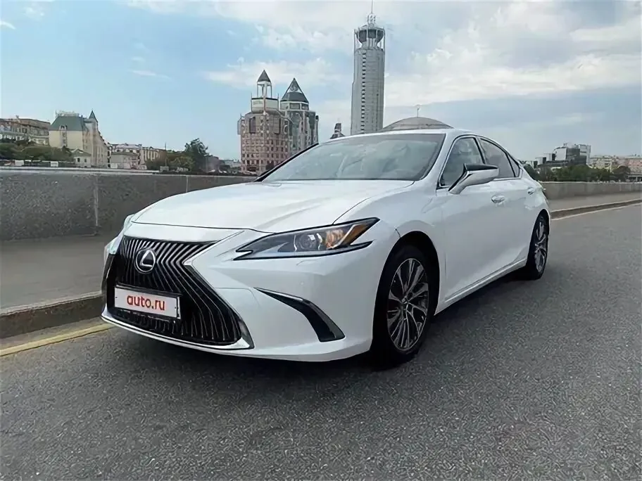White Lexus ES parked on city street.