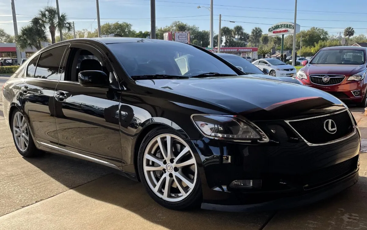 Black Lexus GS 430 parked in dealership lot.