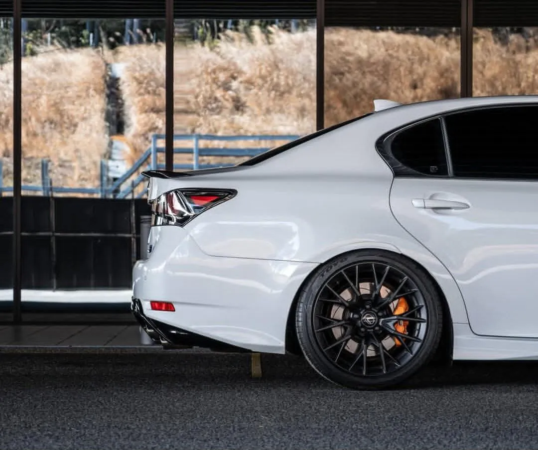 White Lexus GS parked near glass wall