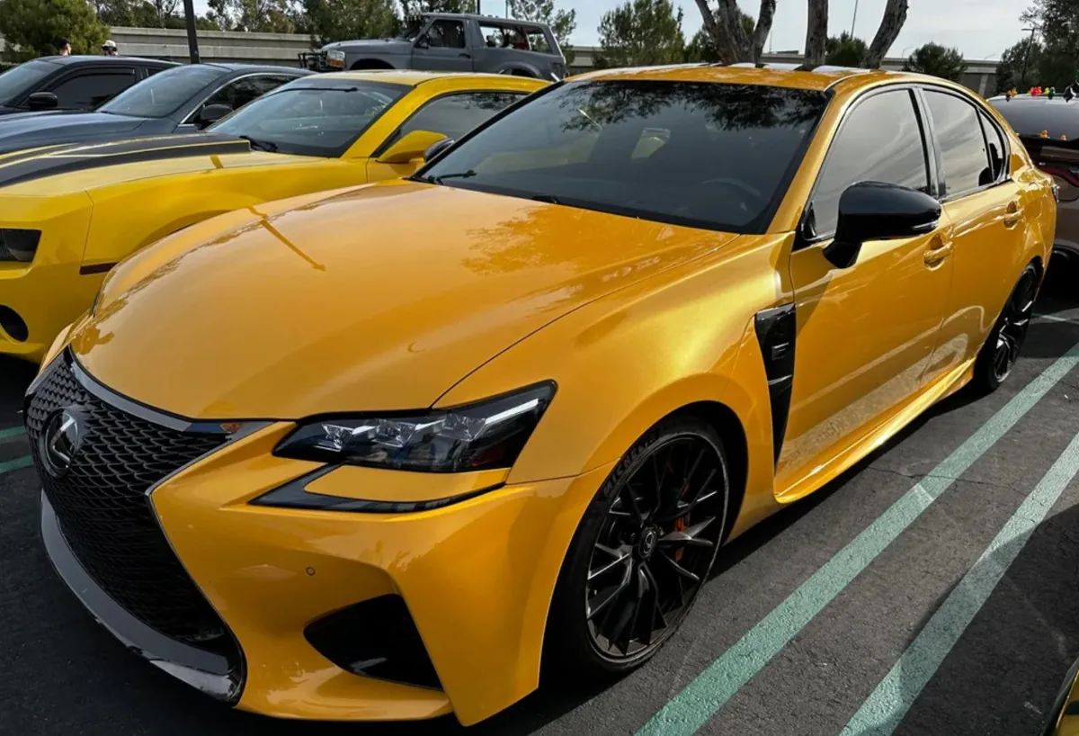 Yellow Lexus GSF parked in a lot.