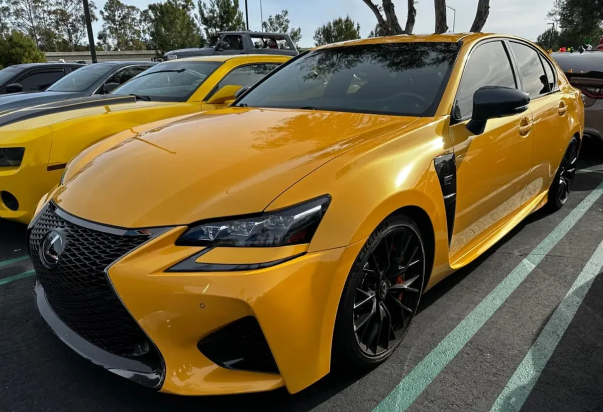 Yellow Lexus GSF parked in a lot.
