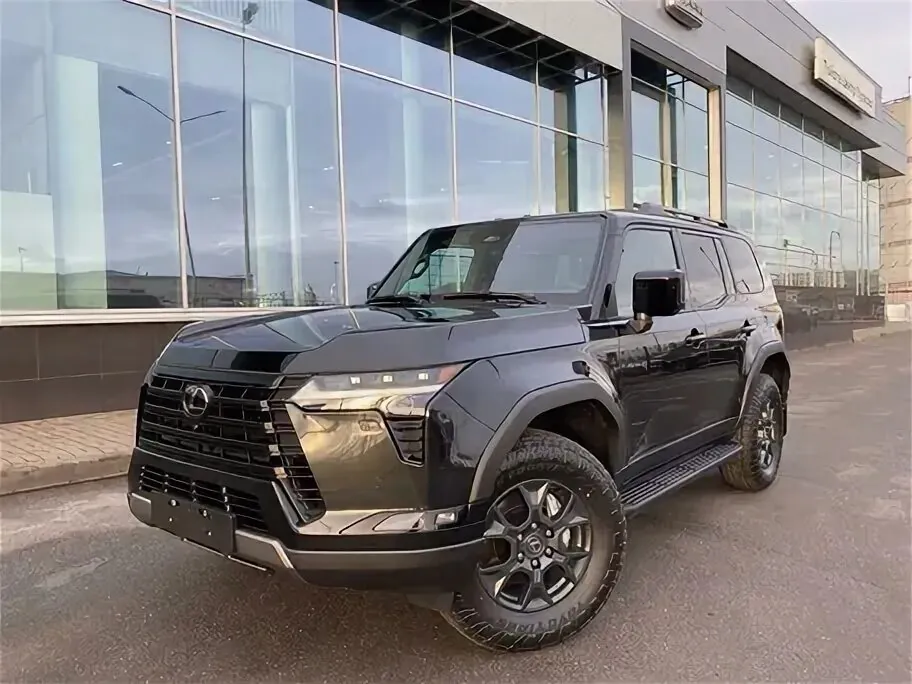 Black Lexus GX 500 parked outside dealership.