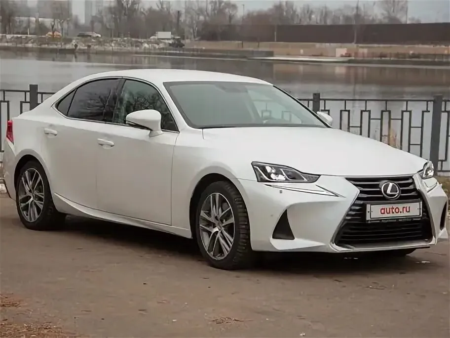 White Lexus IS300 parked by a river.