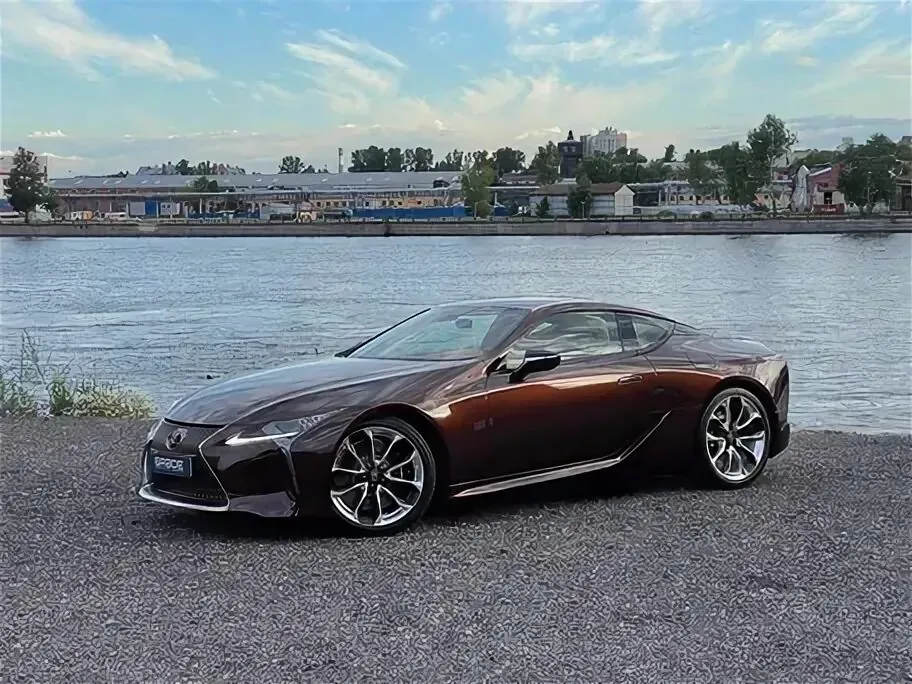 Lexus LC parked by a riverside.