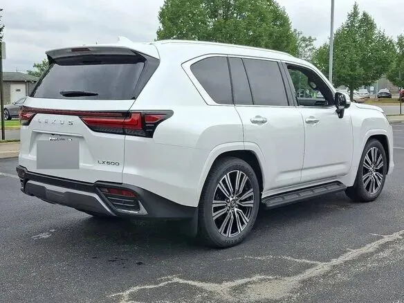 White Lexus LX600 parked in a lot.