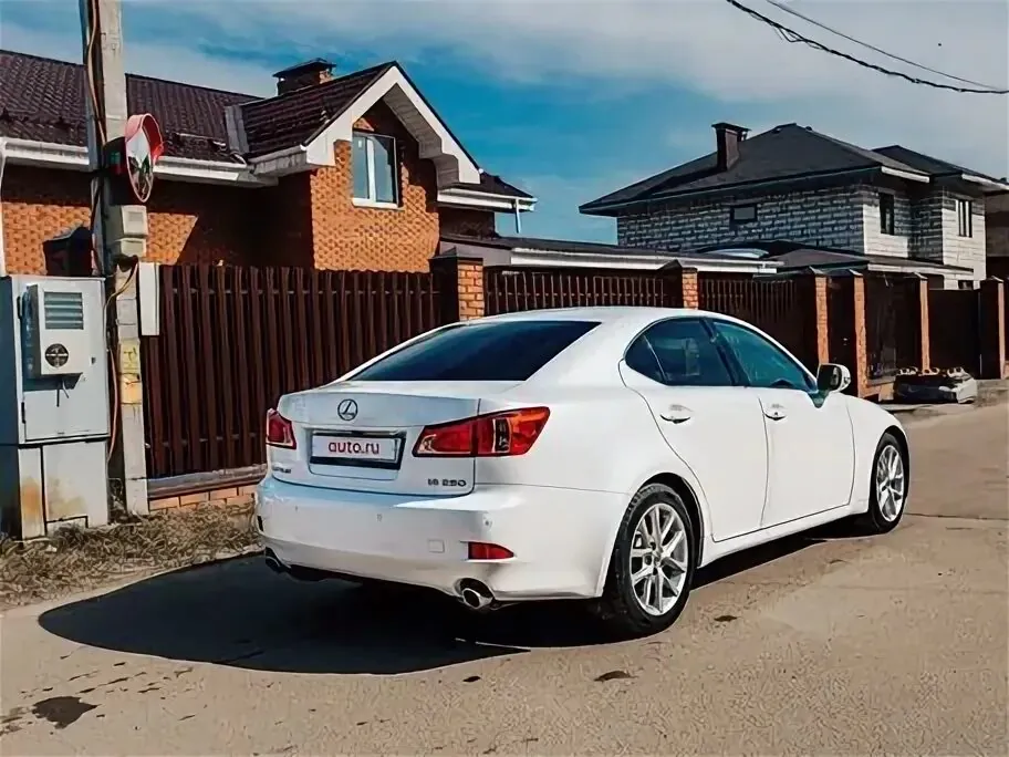 White Lexus IS250 parked on residential street.