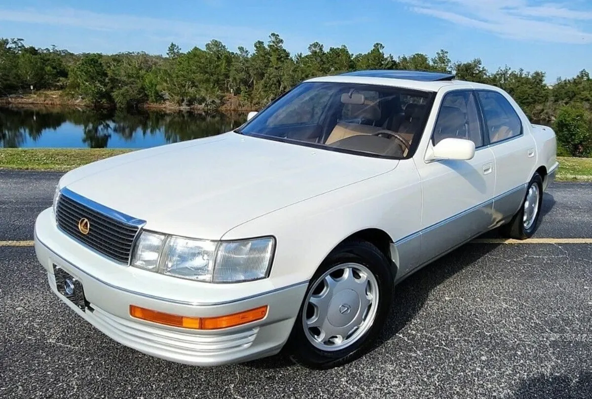 White Lexus LS parked by a lake